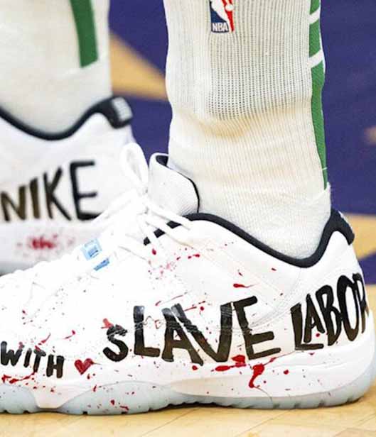 White sneakers that have modern slavery, nike on it